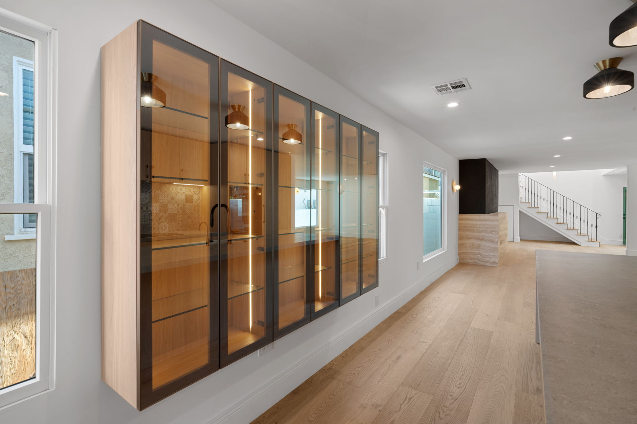 Backlit glass front Italian cabinets in a luxury interior remodel in Manhattan Beach Walk Streets