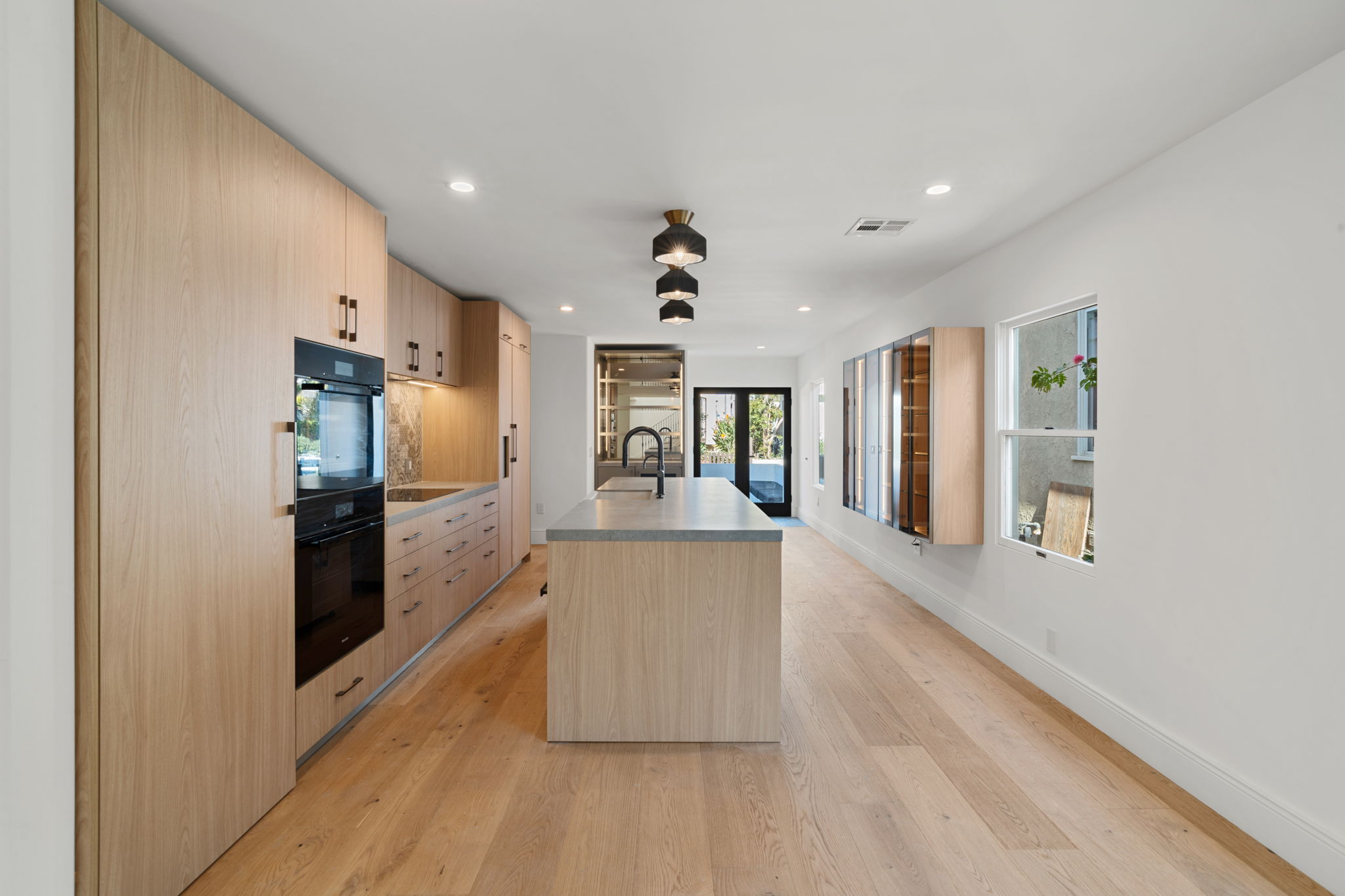 High end Manhattan Beach kitchen remodel with warm wide plank wood floors