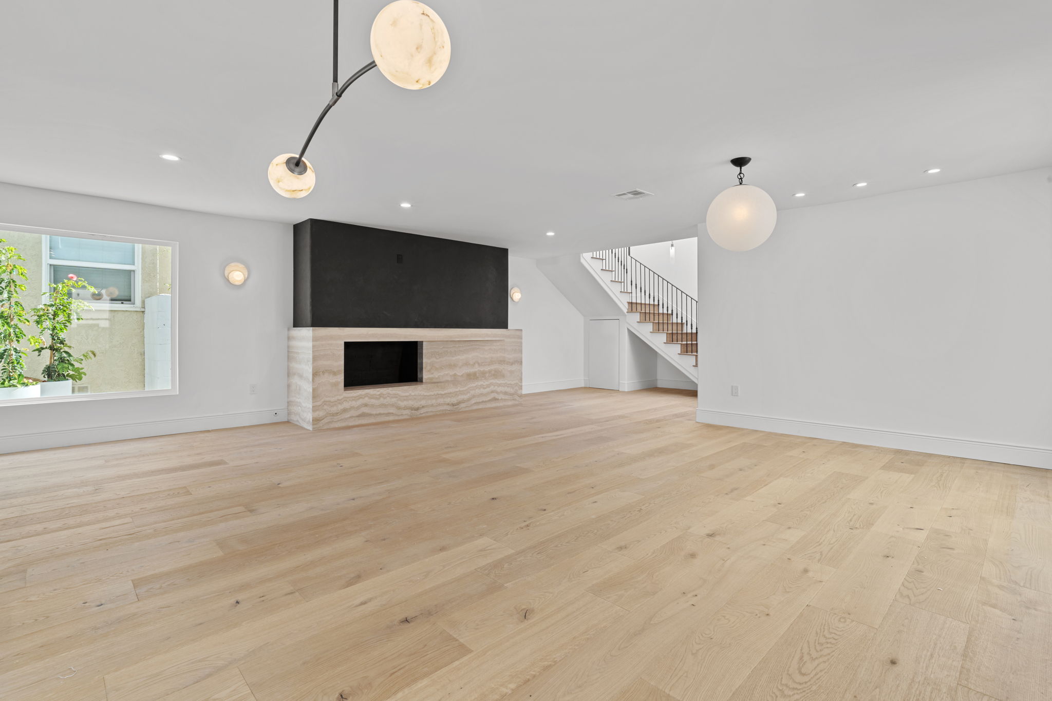 Stone slab fireplace focal point in Walk Streets Manhattan Beach home renovation