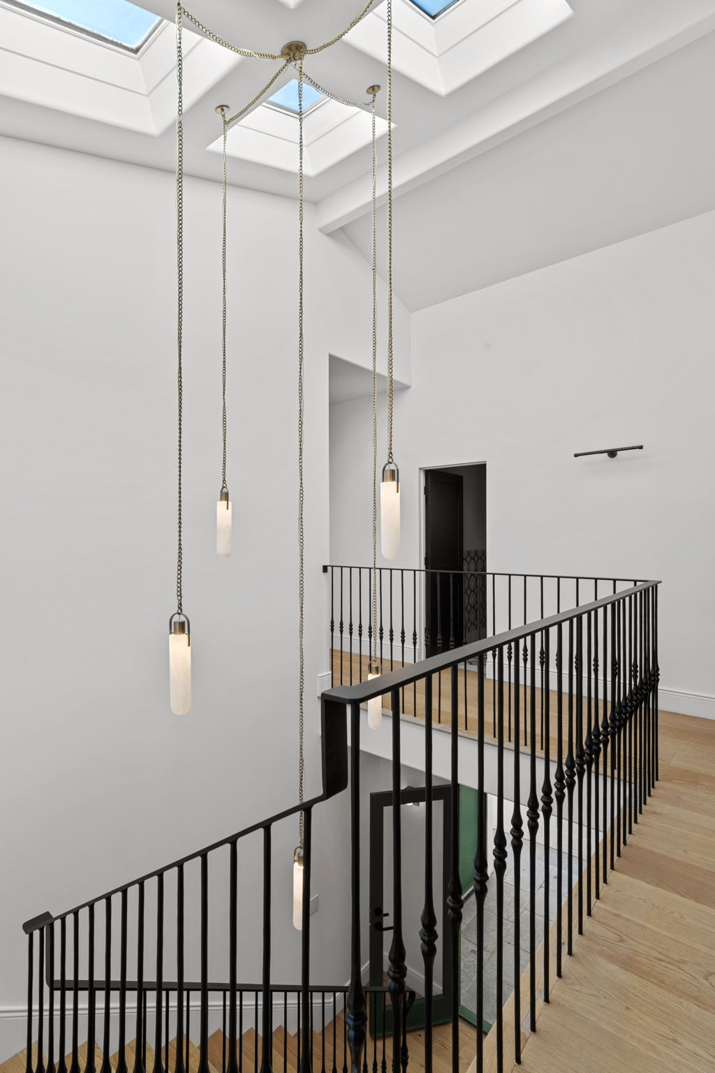 Staircase with skylights and chandelier in Manhattan Beach luxury interior remodel